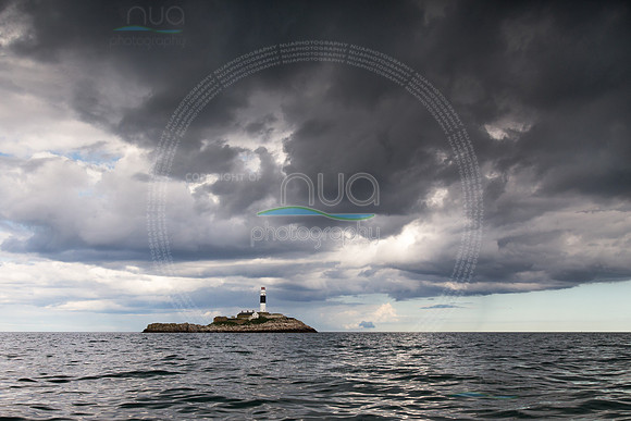 Rockabill Lighthouse under a raincloud
