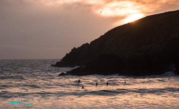 Surfers waiting on a wave In Kilmurrin Cove on the gold Coast waterford